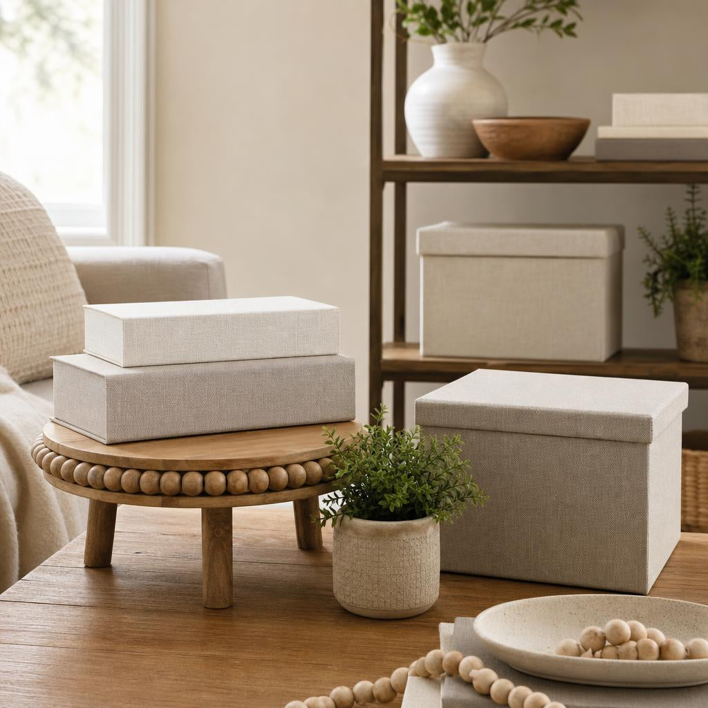 Decorative boxes and woven baskets styled on a coffee table and entryway console